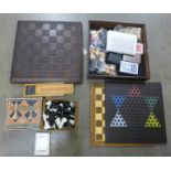 A collection of board games including chess sets, dominoes and playing cards