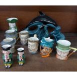 A Poole Pottery dolphin, seal and otter, six character mugs including four Beswick and three