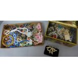 A tin and box of costume jewellery