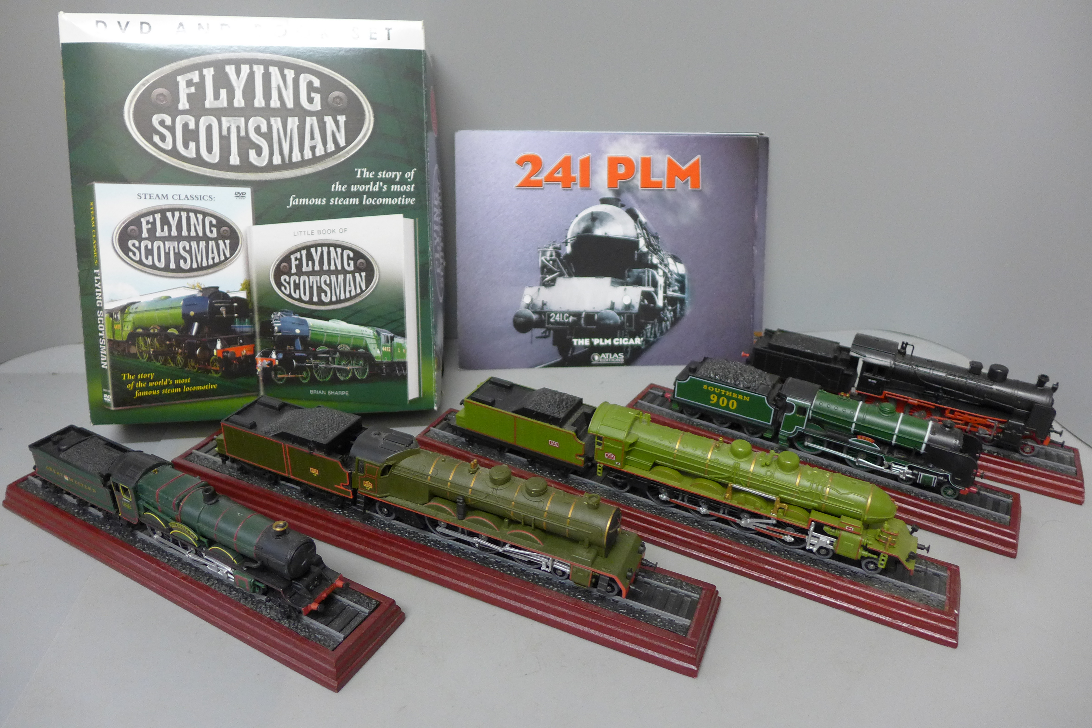 Six models of steam locomotives on wooden plinths and a Flying Scotsman DVD and book set