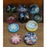 Four Caithness glass paperweights, a Caithness second quality glass paperweight, a Selkirk glass