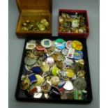 A collection of badges and uniform buttons