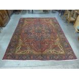 An Iranian red ground Tabriz rug, 385 x 305cms