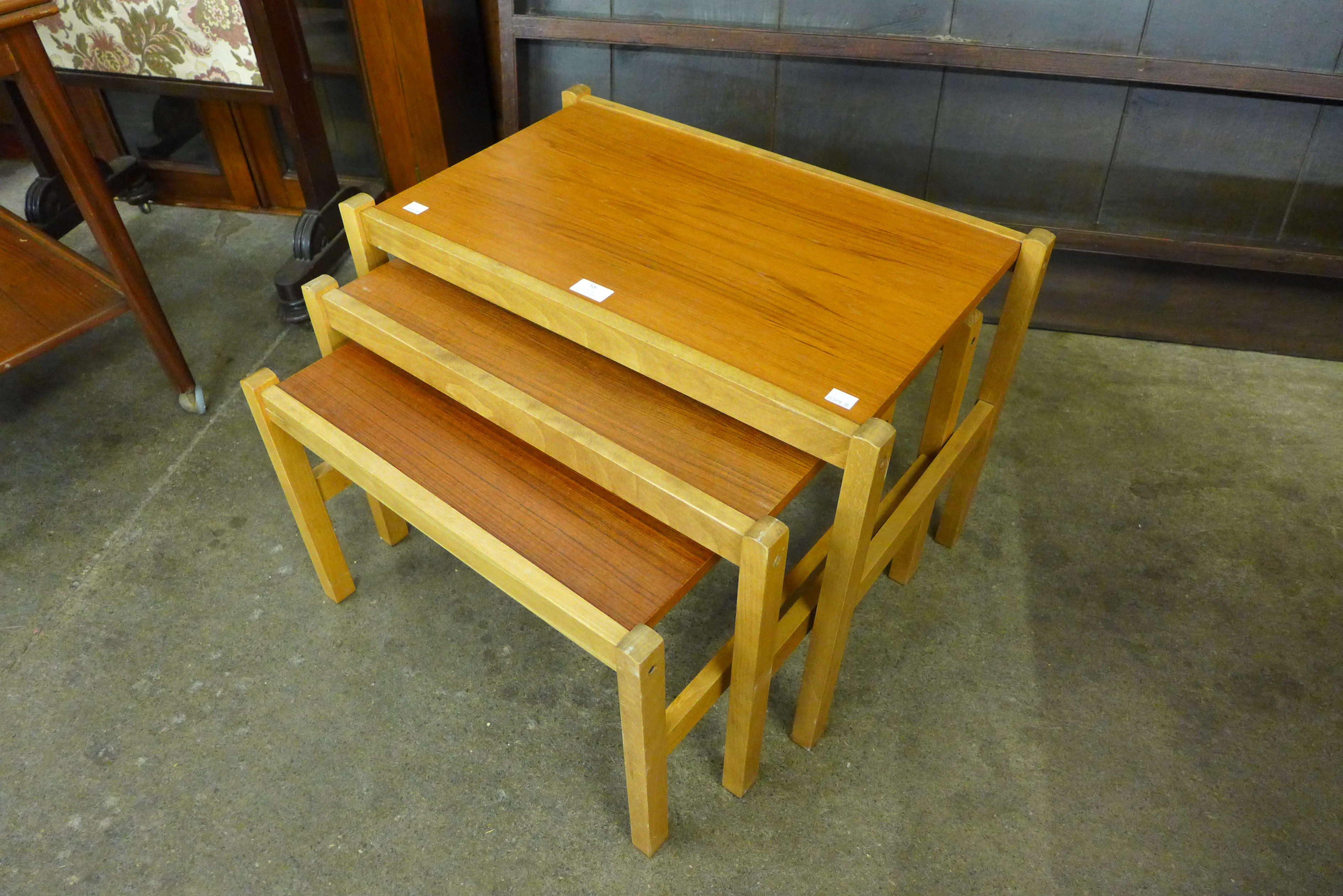 A teak and beech nest of tables