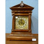 A carved oak mantel clock