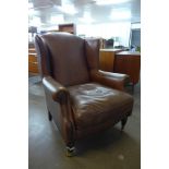 A Laura Ashley brown leather wingback armchair