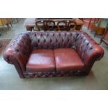 A burgundy leather Chesterfield settee