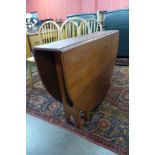 A teak drop-leaf dining table