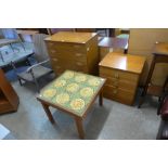 A simulated teak chest of drawers, a teak and tiled top coffee table and one other