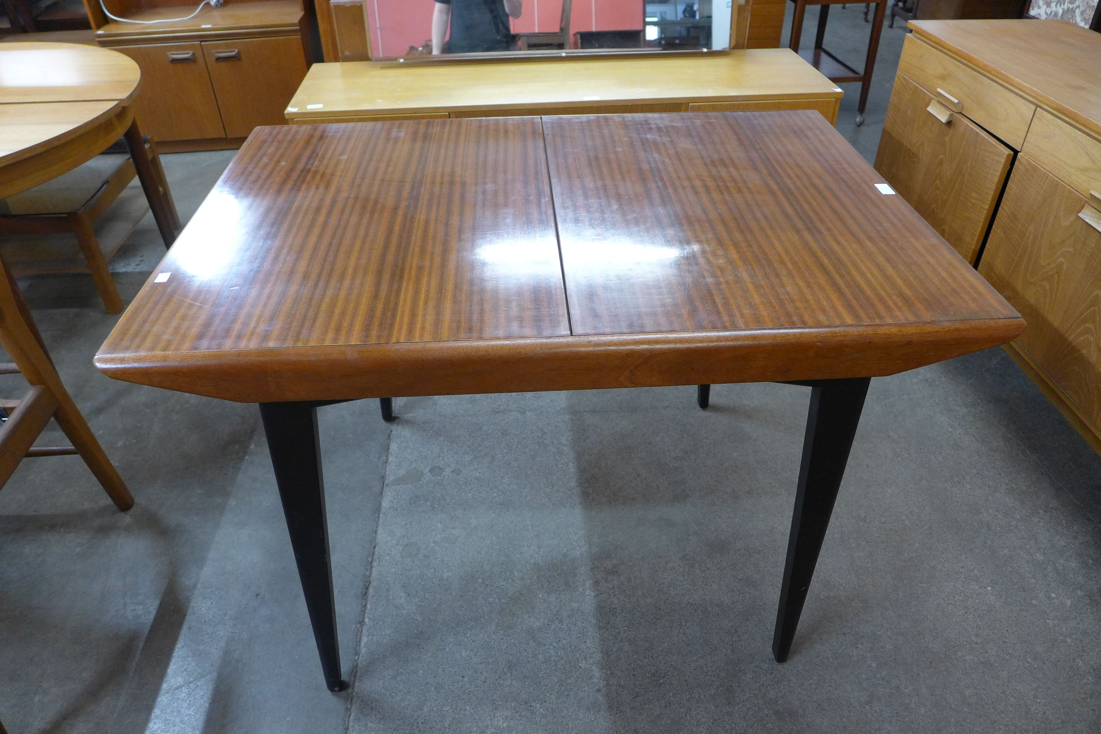 A tola wood and black extending dining table