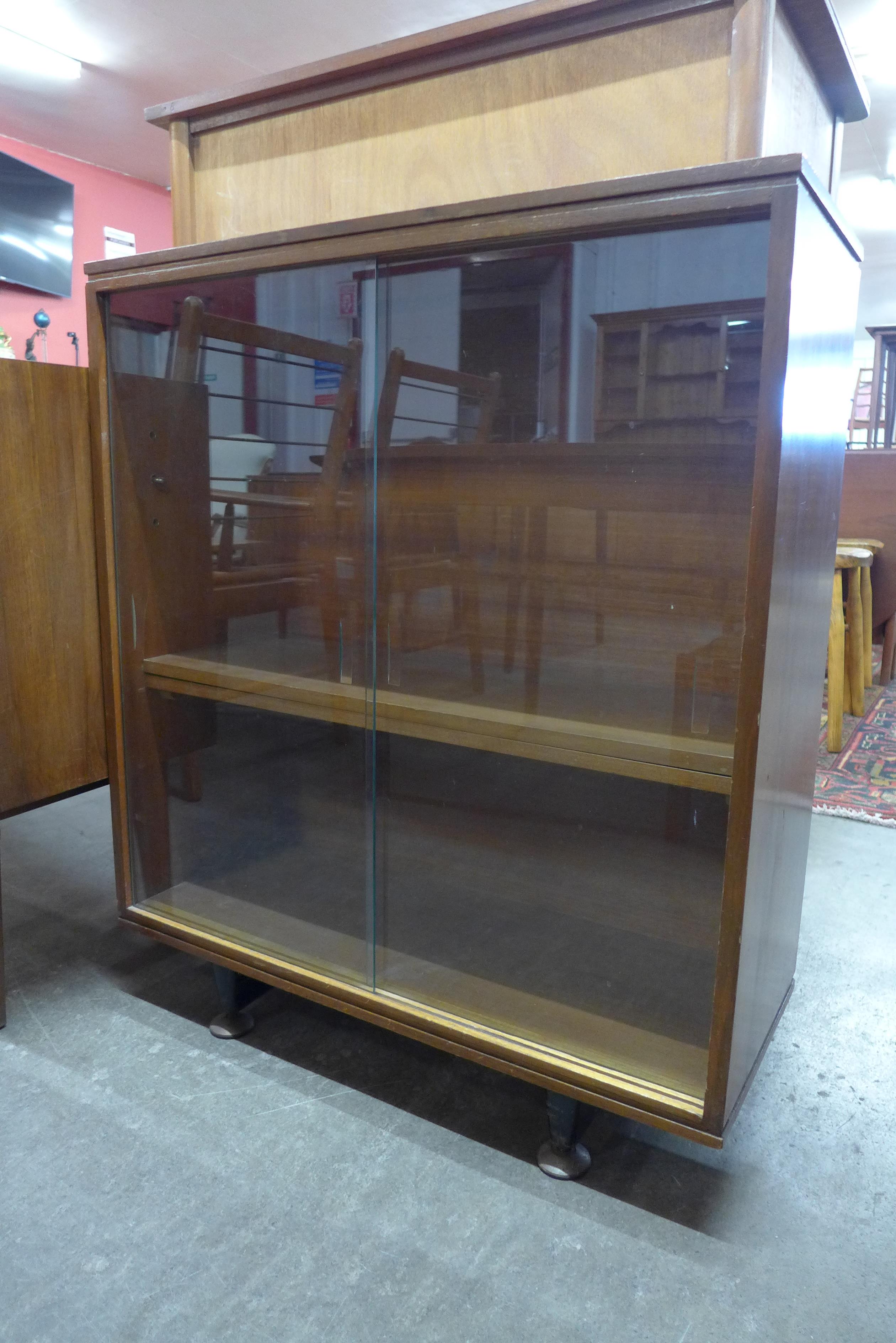 A walnut sliding door bookcase