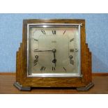 An Art Deco oak mantel clock, dial signed W H May, Nottingham