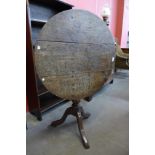 A George III oak tilt-top tripod table