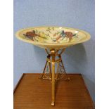 A glass bowl on gilt metal stand