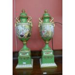 A pair of Italian style green porcelain and parcel gilt vases and covers, decorated with romantic