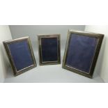 Three silver photograph frames, largest 17cm x 22cm
