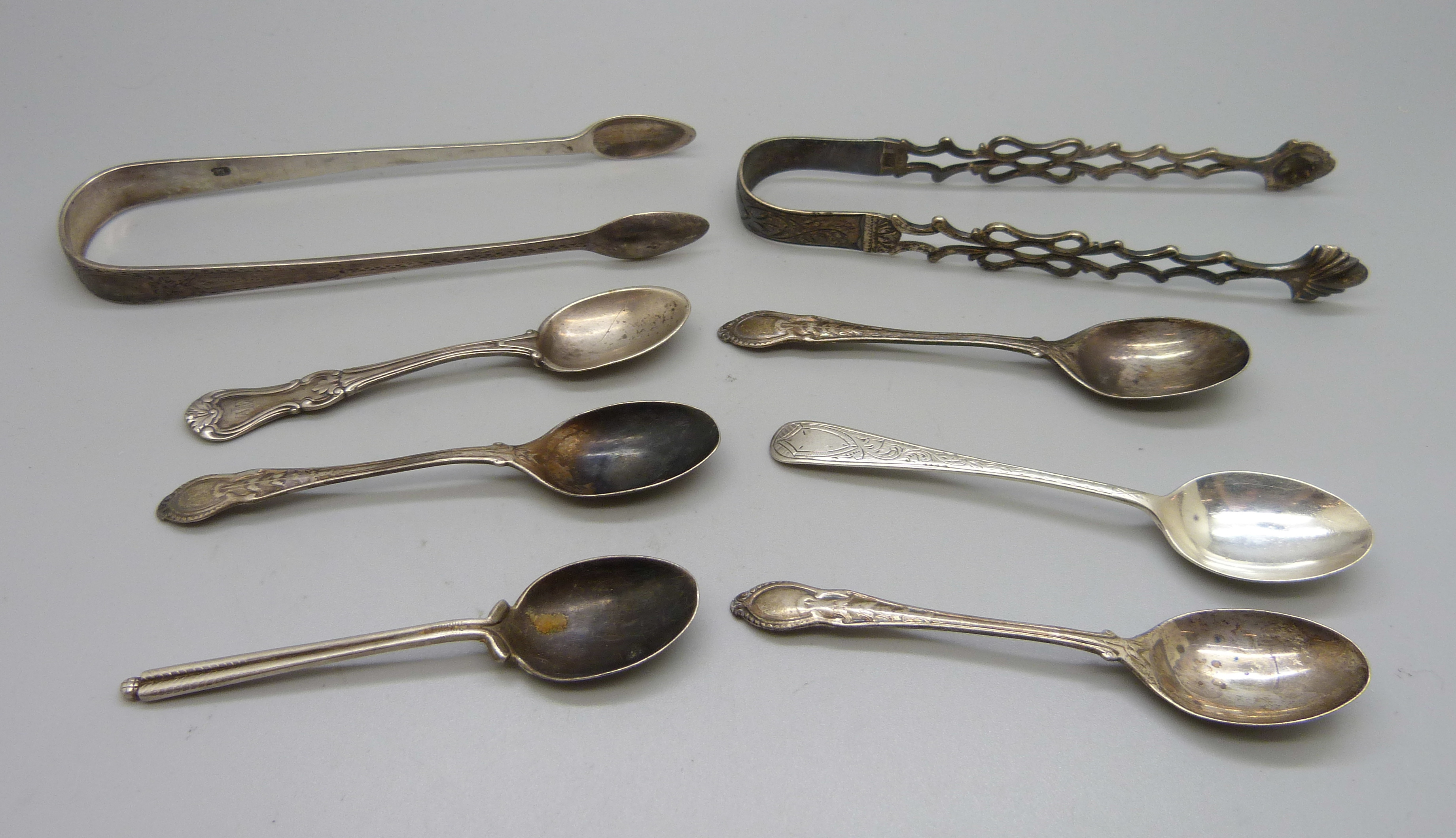 Six silver spoons and two pairs of silver sugar bows, 138g