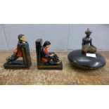 A carved wooden pot with figure and a pair of bookends, a/f