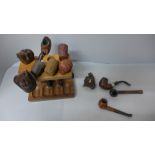 A collection of pipes, some with carved bowls including skull, bulls head, chief and clog, (#35)