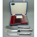 Two silver handled knives, a cake server and a set of six knives