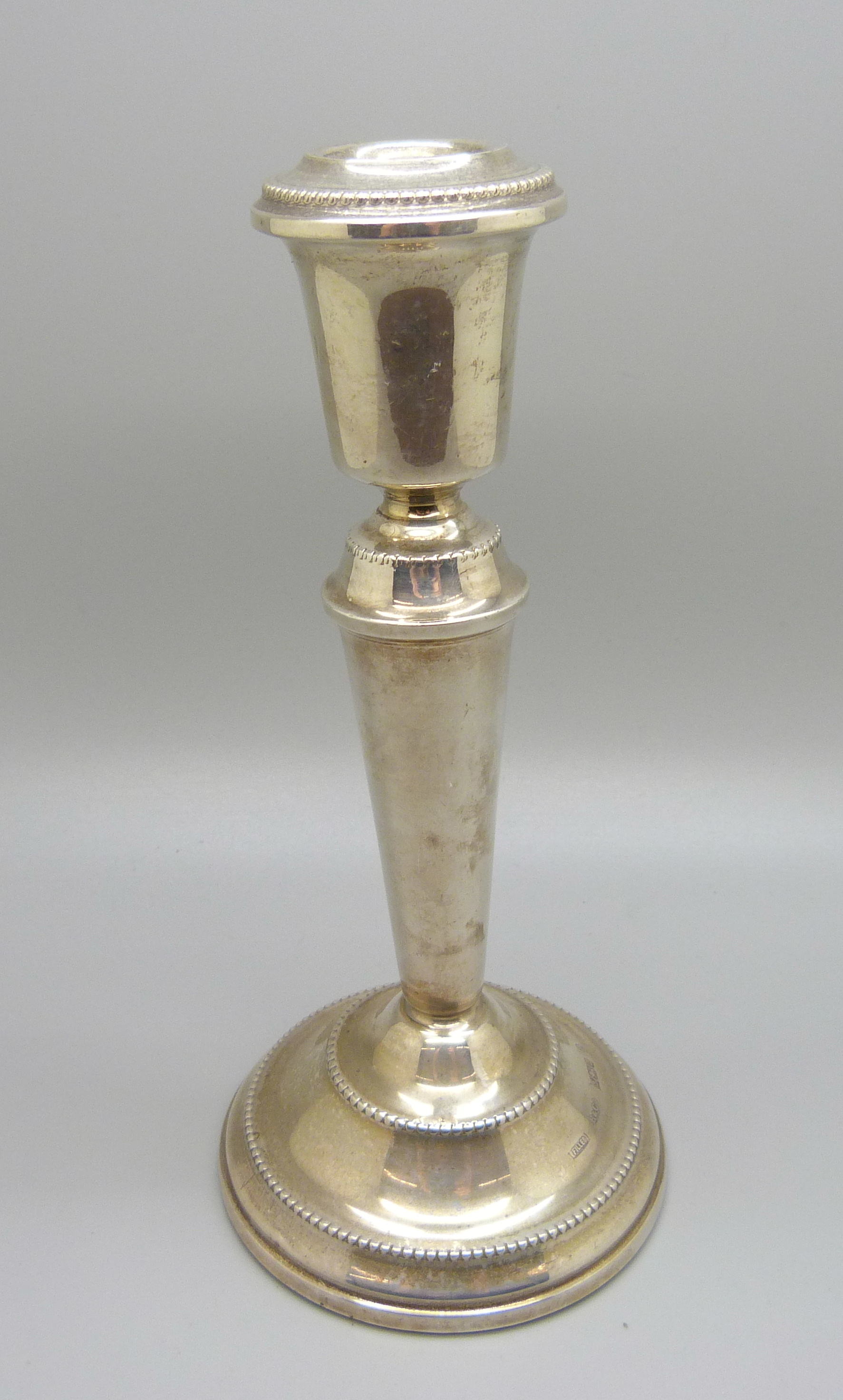 A silver candlestick, Birmingham 1977, 17.5cm, (stem slightly out of shape)