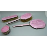 A silver and pink enamel hand mirror, two brushes and a trinket pot, a/f