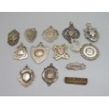 Eleven silver fob medals including one Irish silver with inscription, 'LSFA Wigoder Cup, Won by