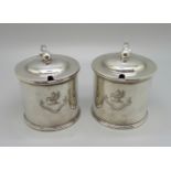 A pair of silver mustards, with crests, one lacking liner, 315g