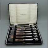 A cased set of six dessert knives, Sheffield 1923, with silver covered handles