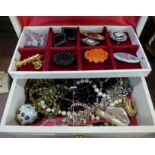 A jewellery box containing hat pins and brooches