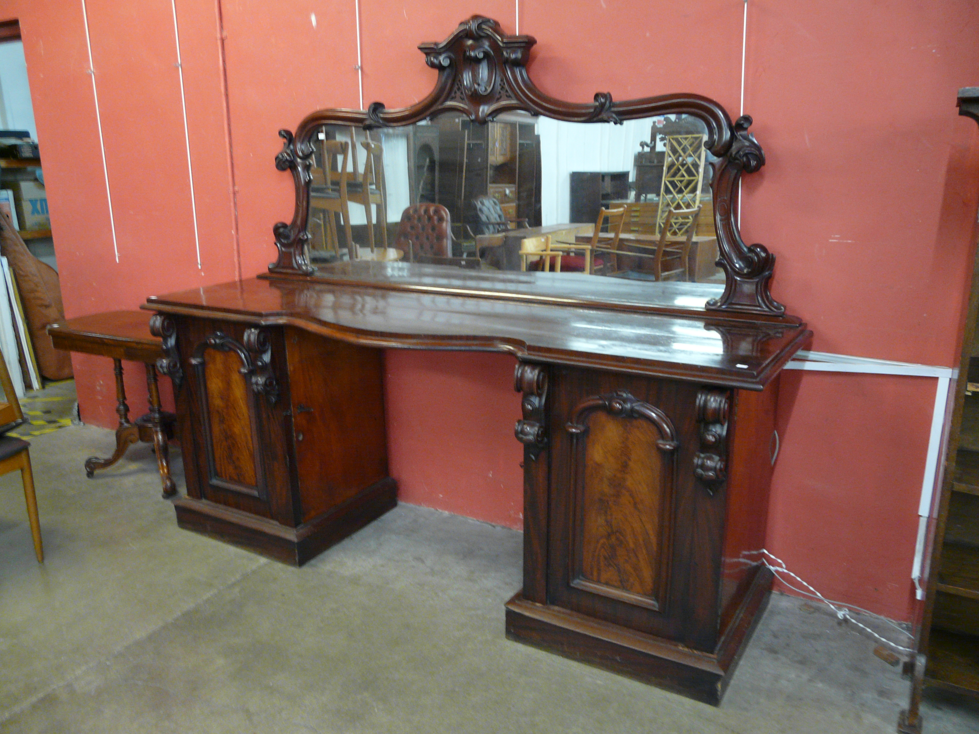 A Victorian carved mahogany mirrorback pedestal sideboard