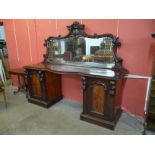 A Victorian carved mahogany mirrorback pedestal sideboard