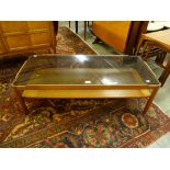 A teak and glass topped coffee table