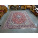 A fine Persian red ground Kashan rug, 400 x 307cms