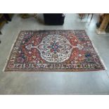 An eastern red ground rug, 250 x 178cms