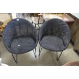 A pair of metal and wicker chairs