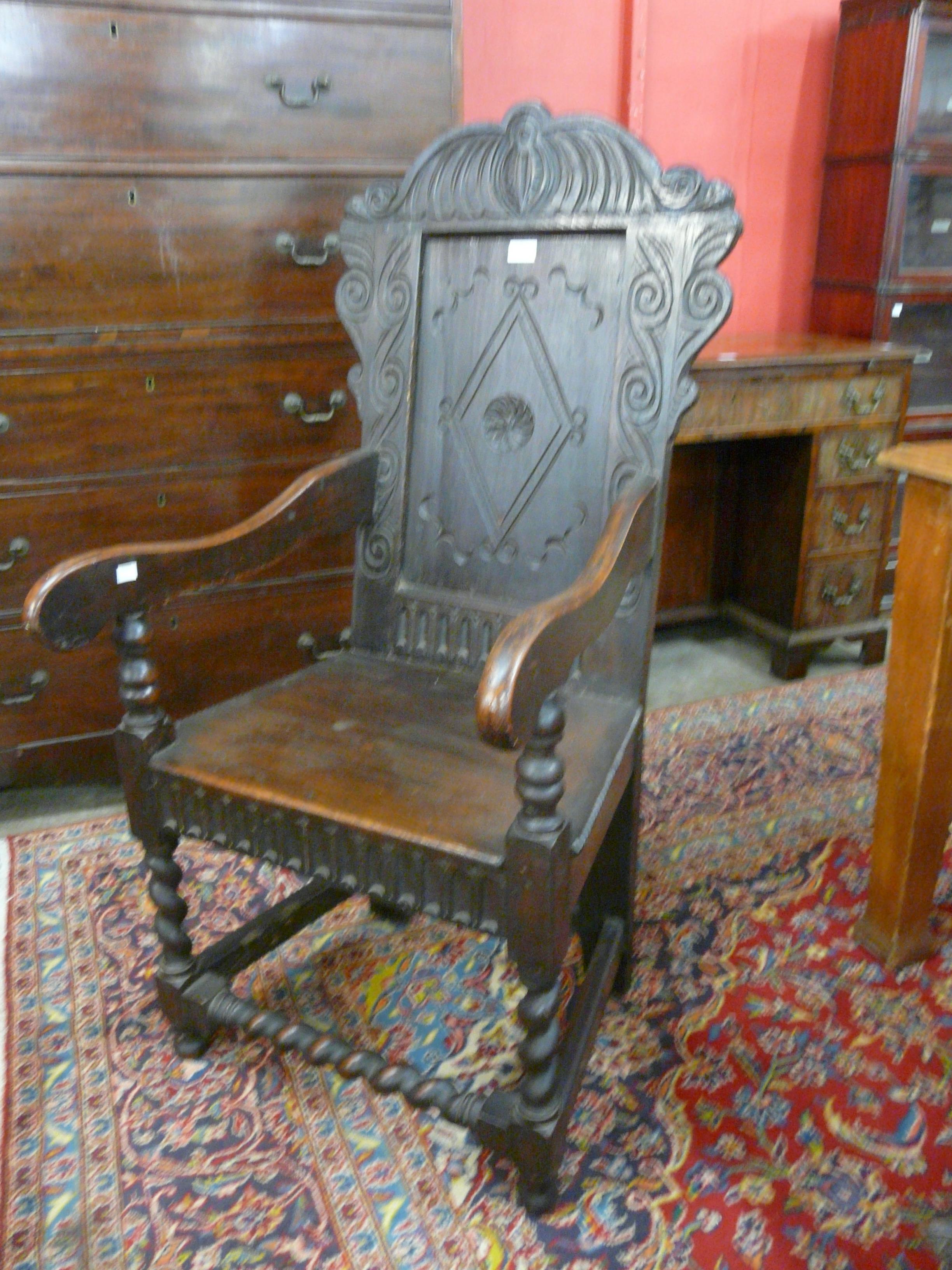 A 17th Century style carved oak Wainscot chair