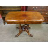 A Victorian mahogany fold over games table