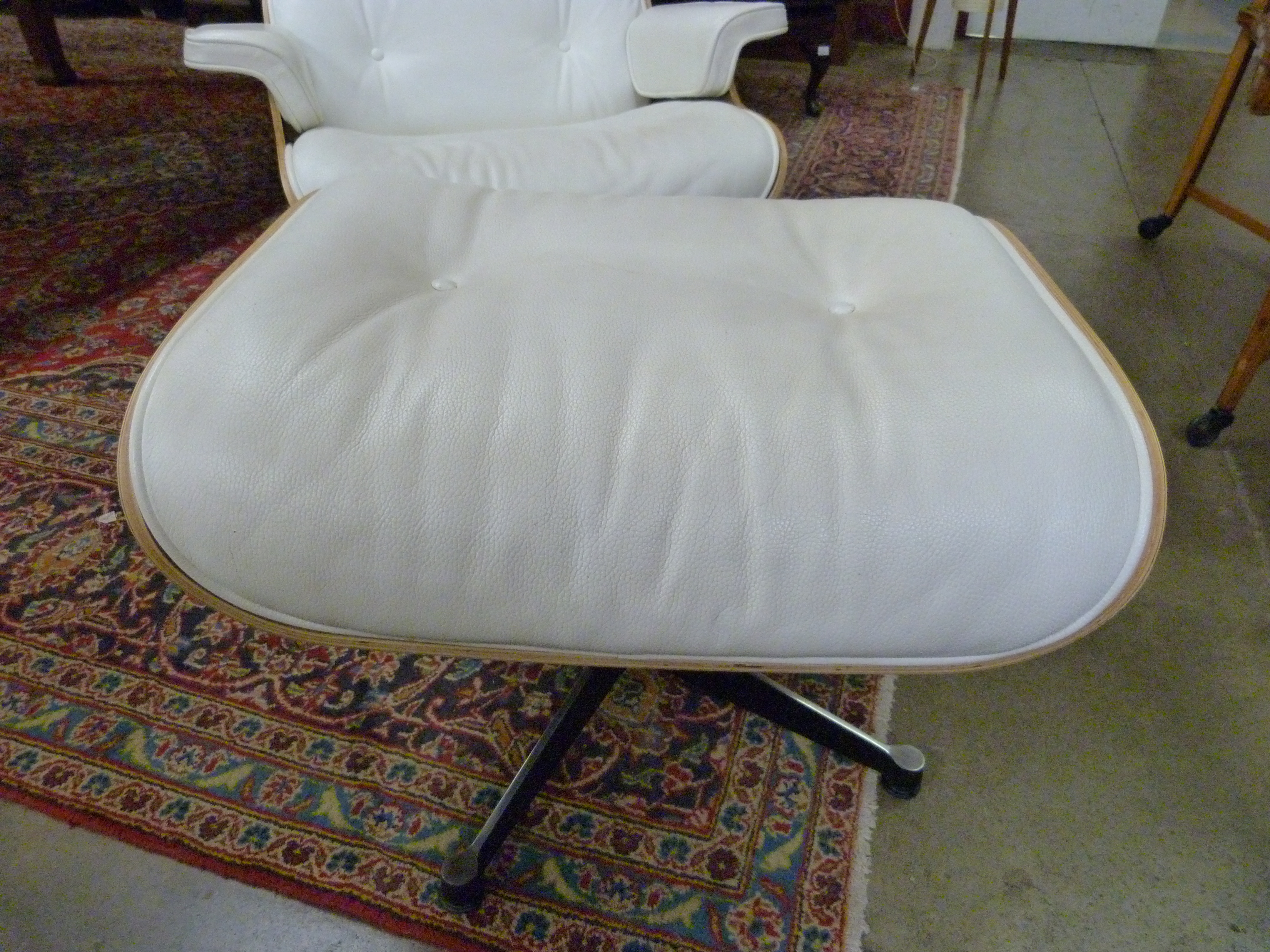 A Charles & Ray Eames style simulated rosewood and cream leather revolving lounge chair and stool - Image 3 of 3