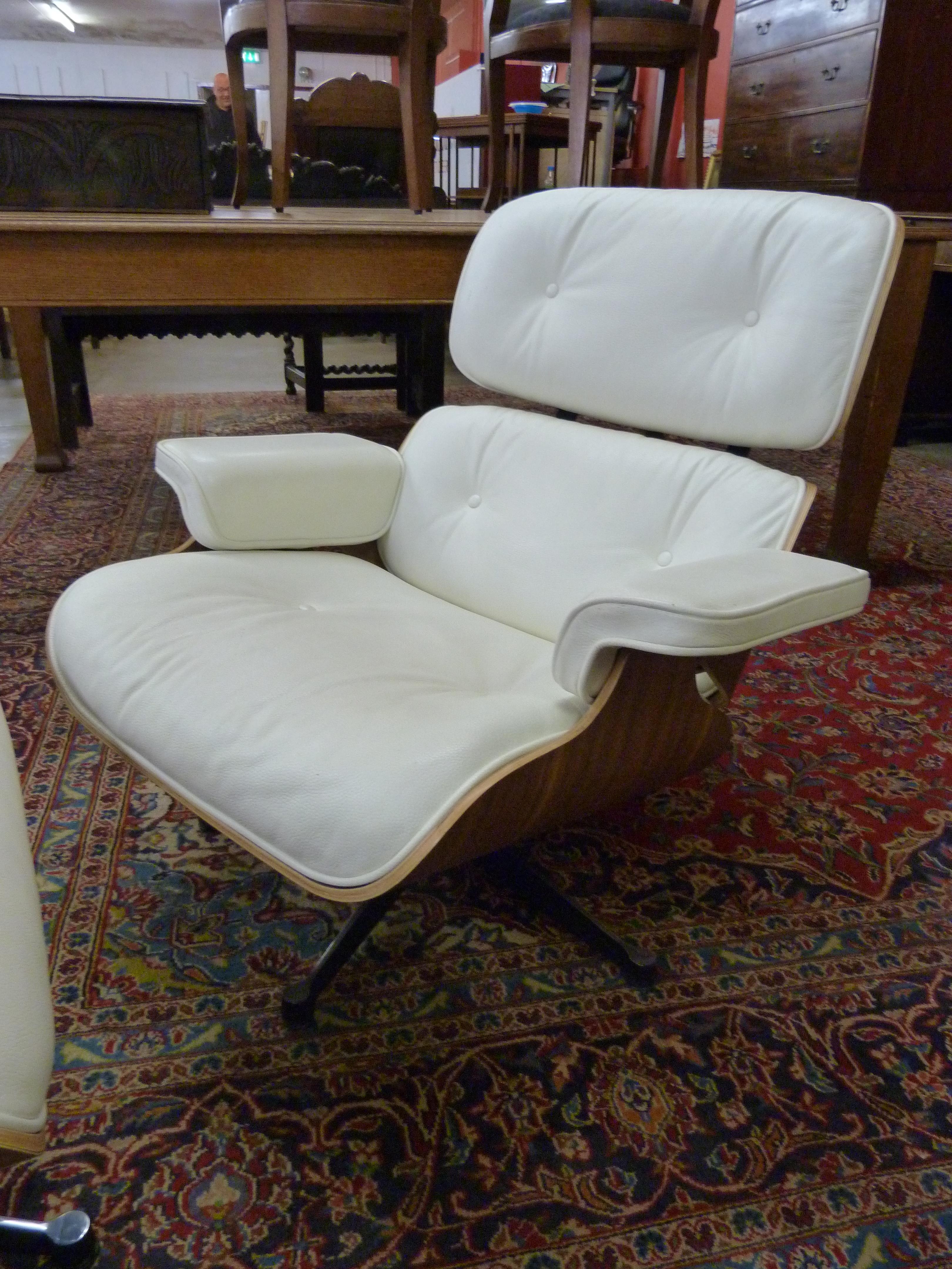 A Charles & Ray Eames style simulated rosewood and cream leather revolving lounge chair and stool - Image 2 of 3