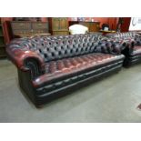 An oxblood red leather Chesterfield settee