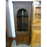 A carved Ipswich oak freestanding corner cabinet