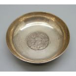 An Iranian silver dish, inset with a late 19th Century coin, marked 84, 91g, diameter 85mm