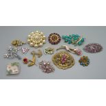 A collection of vintage costume brooches