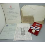 A Queen's Silver Jubilee Medal, cased, with paperwork