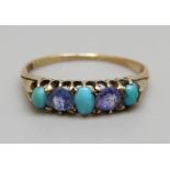 A vintage yellow metal ring, set with turquoise and two replacement blue stones, 2.2g, O