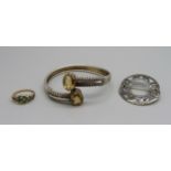 A white metal and citrine bangle, a silver brooch and a ring lacking turquoise