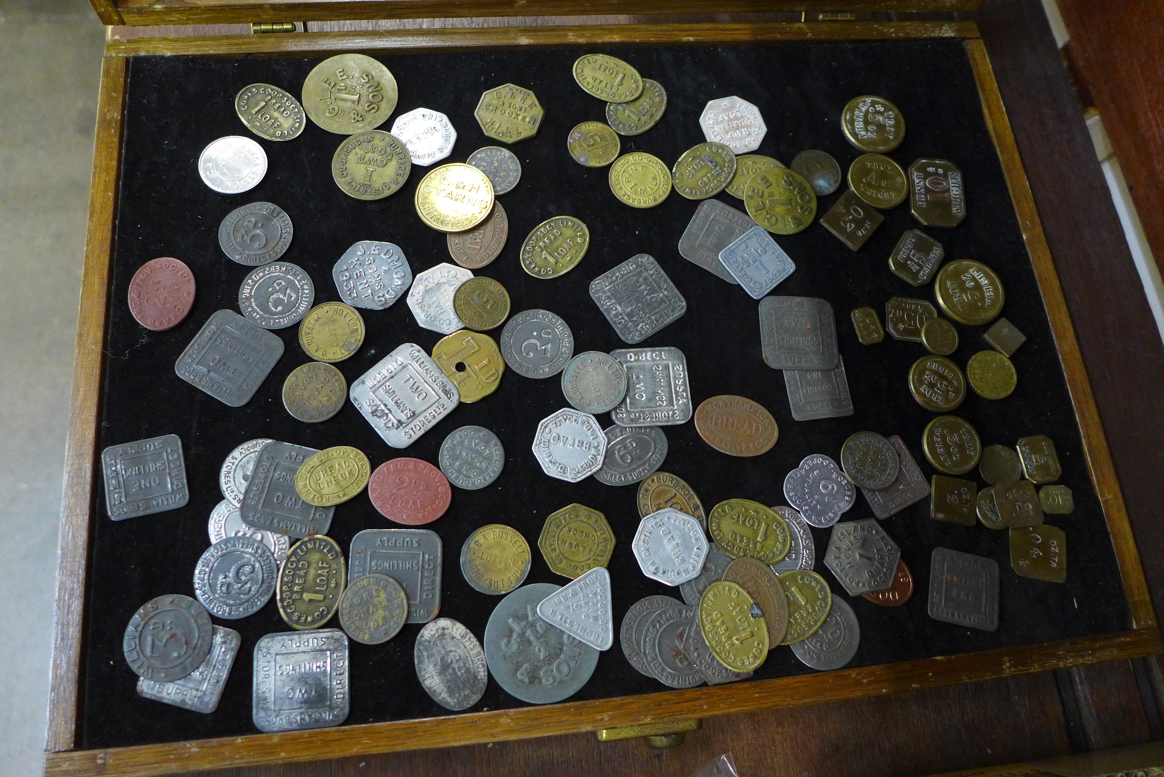 A case containing troy weights and trade tokens including L & H Starns, Spitalfields