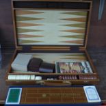 A cased Backgammon set and a Cribbage set, boxed