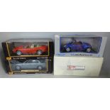 Four 1:18 model cars including two Maisto, all boxed